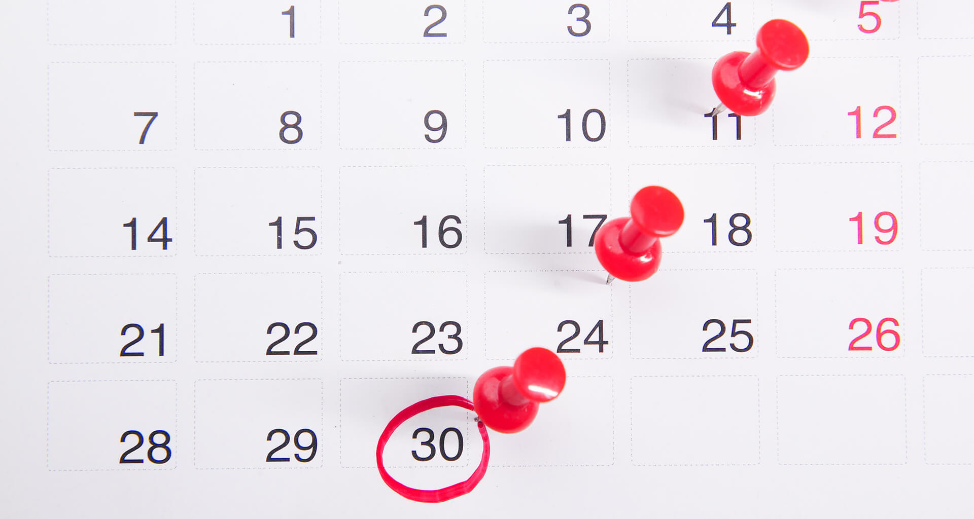 Calendar with red pins on dates